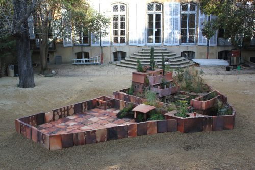 Huang Yong Ping, Abbottabad, 2013. Terracotta, compost, wood ships, printed canvas, and plywood, installed: 53 1/4 × 452 3/4 × 196 7/8 in. (135.3 × 1150 × 500.1 cm). Joseph H. Hirshhorn Purchase Fund, 2016. Photo courtesy the artist and Gladstone Gallery, New York and Brussels
