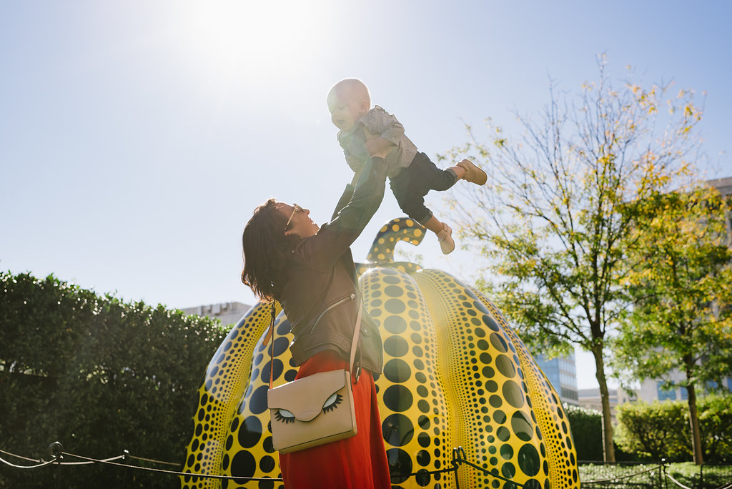 Visitor with babe in front of Yayoi Kusama: Pumpkin on Hirshhorn plaza