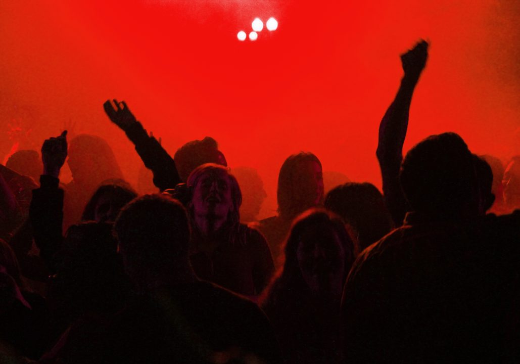 Crowd dancing in red light