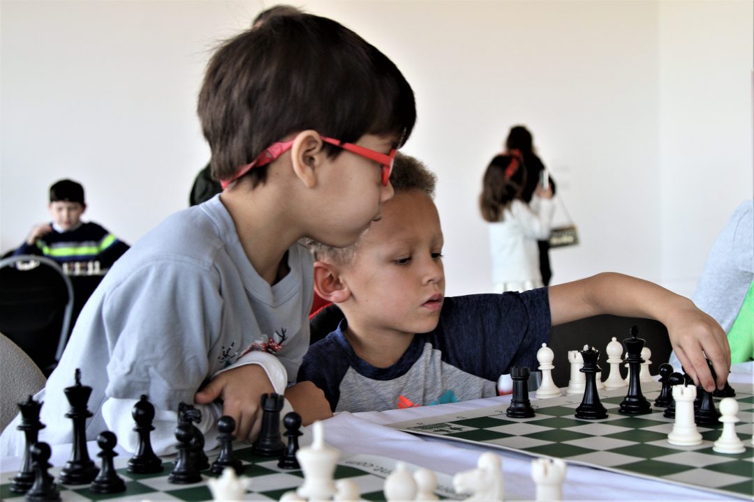 Two children play chess