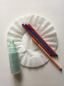 coffee filter, markers, spritz bottle, tape and a piece of paper