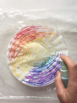 colored coffee filter being sprayed down with water