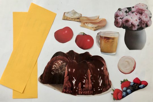 Arrangement of yellow paper strips and cutouts of chocolate cake, tomatoes, berries, cup of coffee, crackers, and a vase.