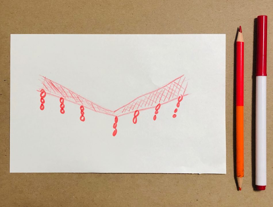 A sketch of a red V-shaped web with looped strings hanging down. A red pencil and red marker rest beside the paper.