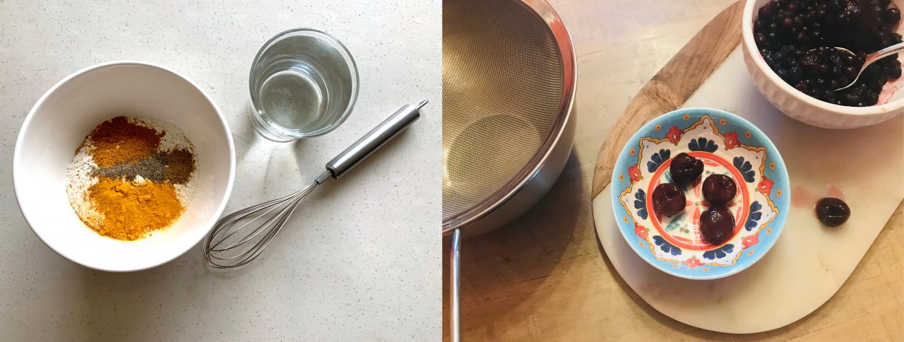 An arrangement of ingredients. On the left, a bowl with the dry mixture is next to a whisk and glass of water. On the right, an arrangement of berries, a bowl, and a colander.