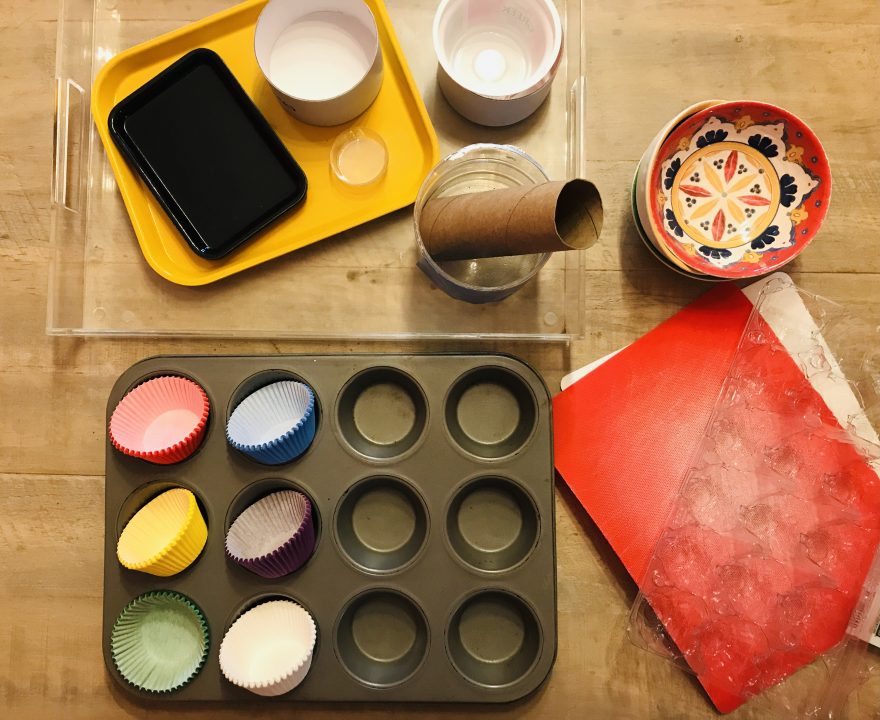 Cooking tray with colorful cupcake liner, bowls,and other knick knacks