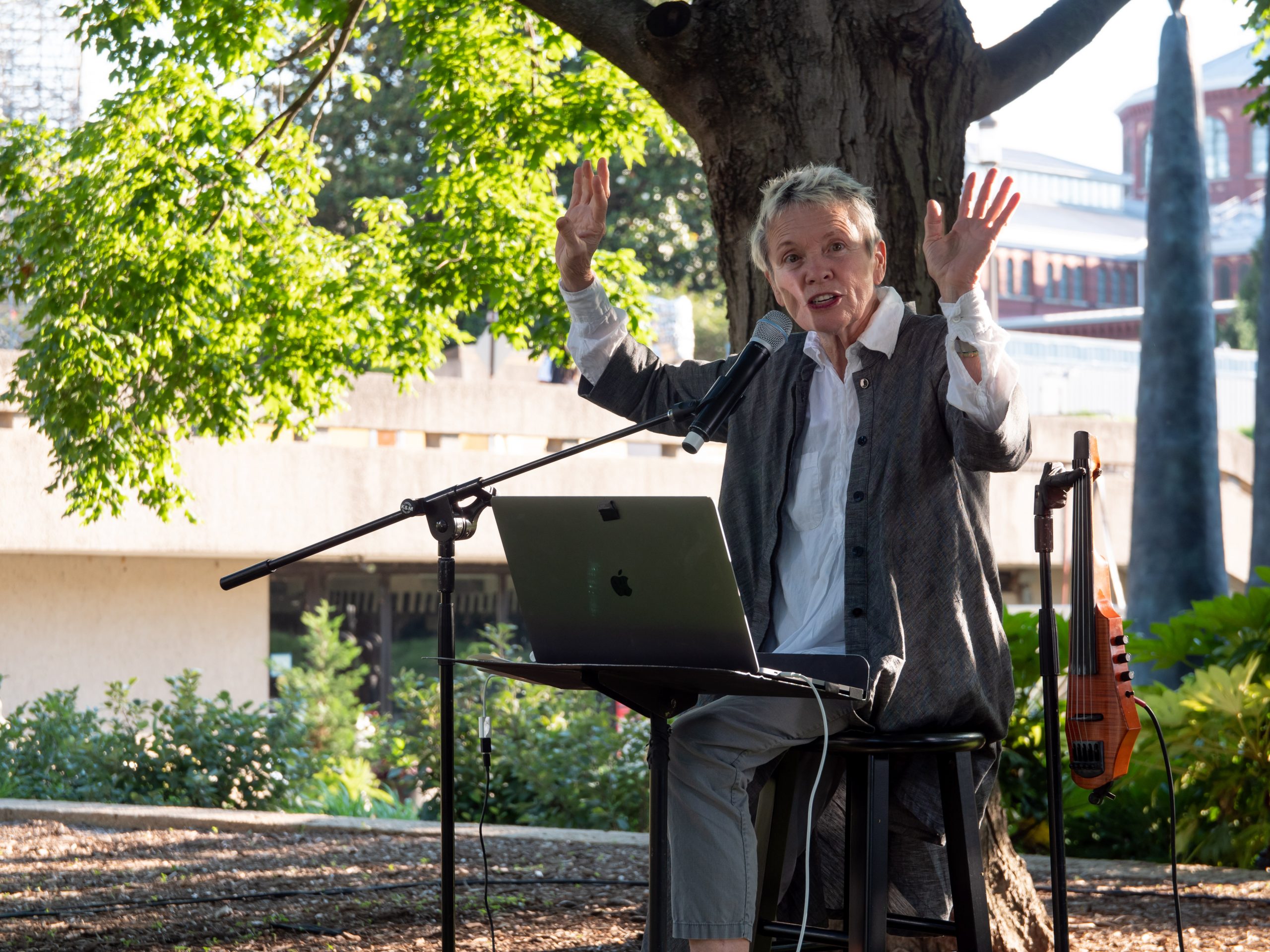 Artist Laurie Anderson sitting in the Hirshhorn's Sculpture Garden