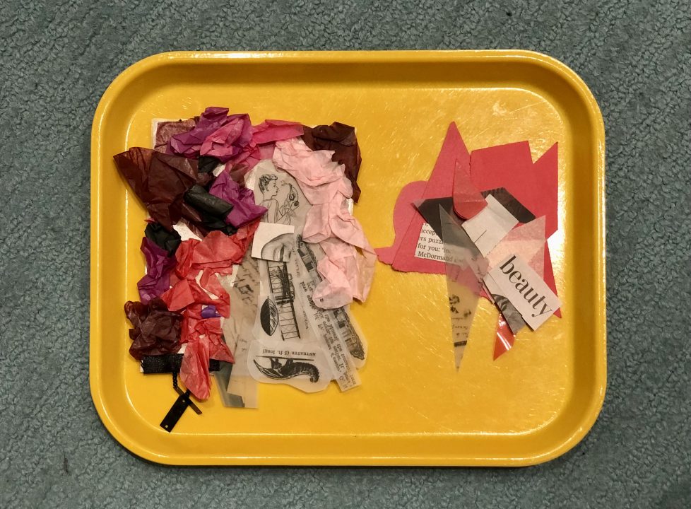 A yellow plastic tray sits atop a carpeted floor.