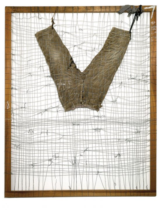 Pants hung upside down in a frame with woven wires through frame