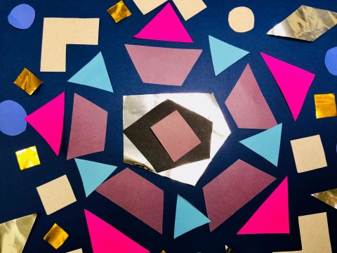 A mosaic with tin foil cut into a pentagon shape at the center surrounded by neon pink triangles, translucent trapezoids, sky blue triangles, and metallic squares, circles, and diamonds on a dark blue background.