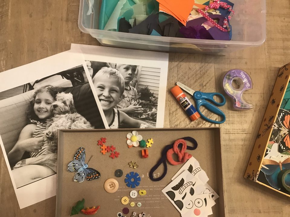 An assortment of materials including: black and white portrait photographs, a glue stick, scissors, tape, and containers with assorted loose parts, assorted imagery and colorful paper