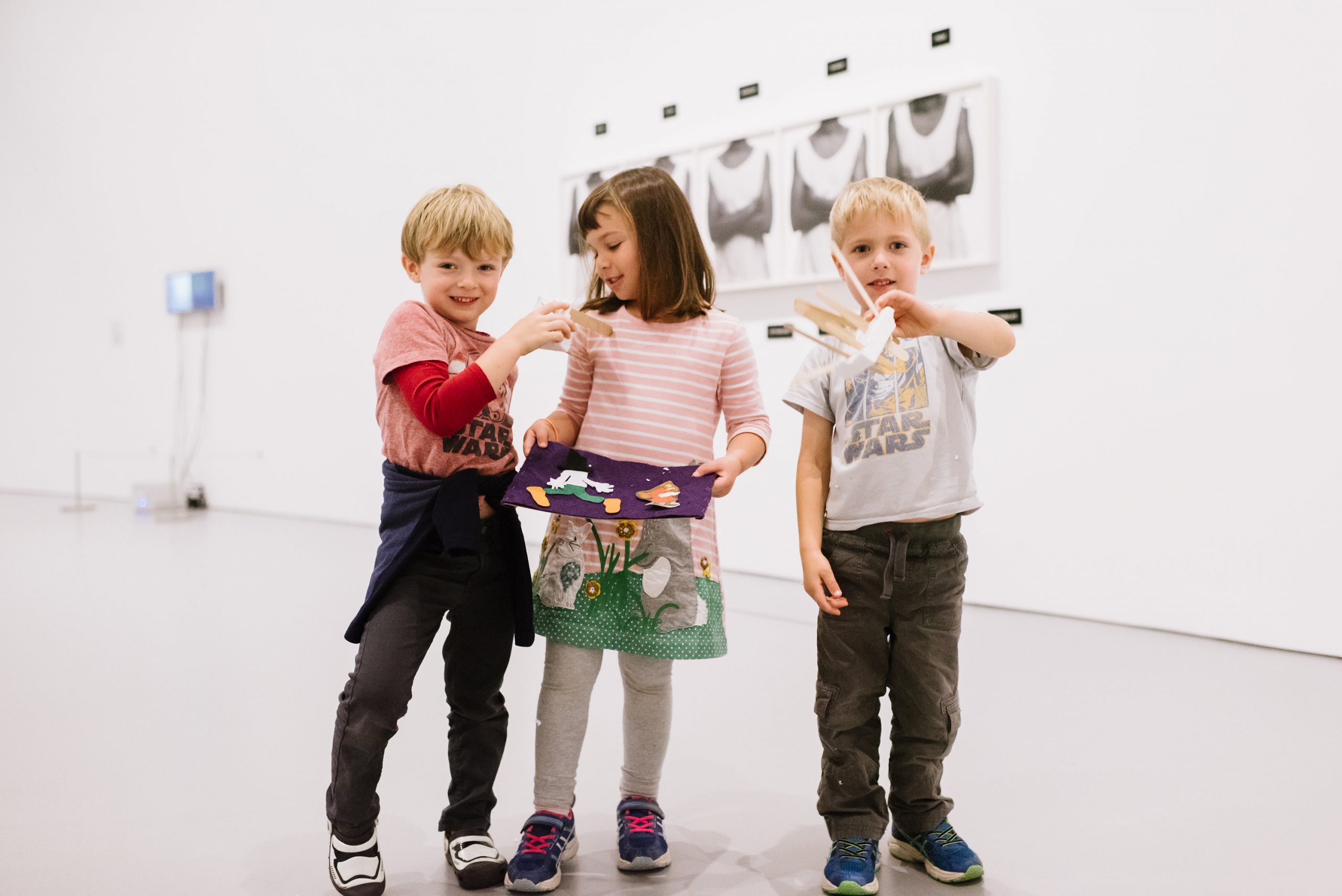 children playing with crafts in an art gallery