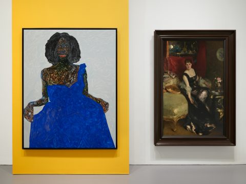 There are two portraits of women, displayed side by side. the woman in the painting on the left is wearing a cobalt blue dress and the woman in the painting on the right is wearing a black dress.