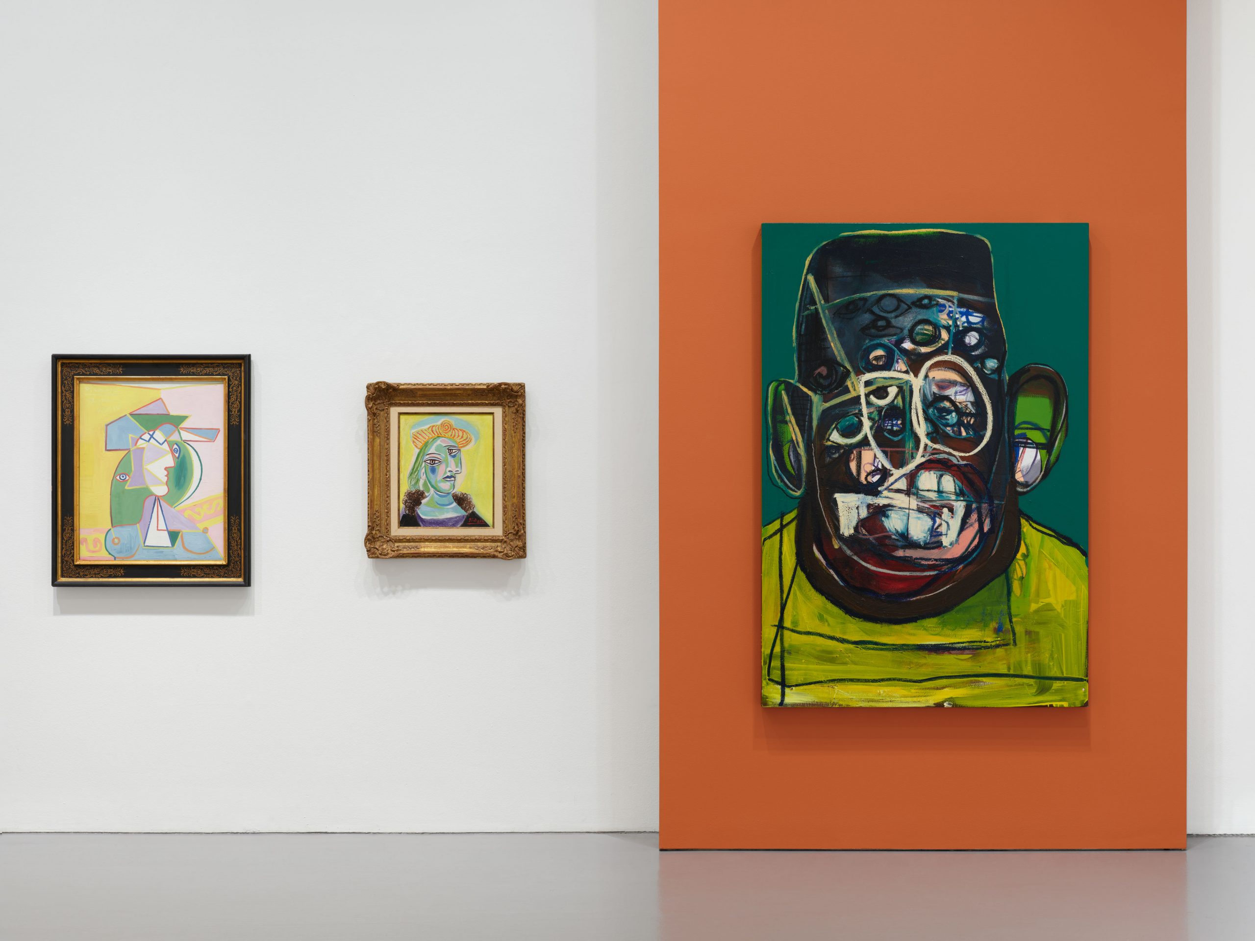 Interior view of an art gallery showcasing multiple paintings on the walls.