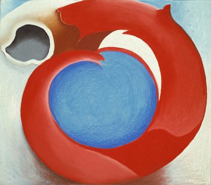 A red circle with blue in the model surrounded by a white brown and blue background