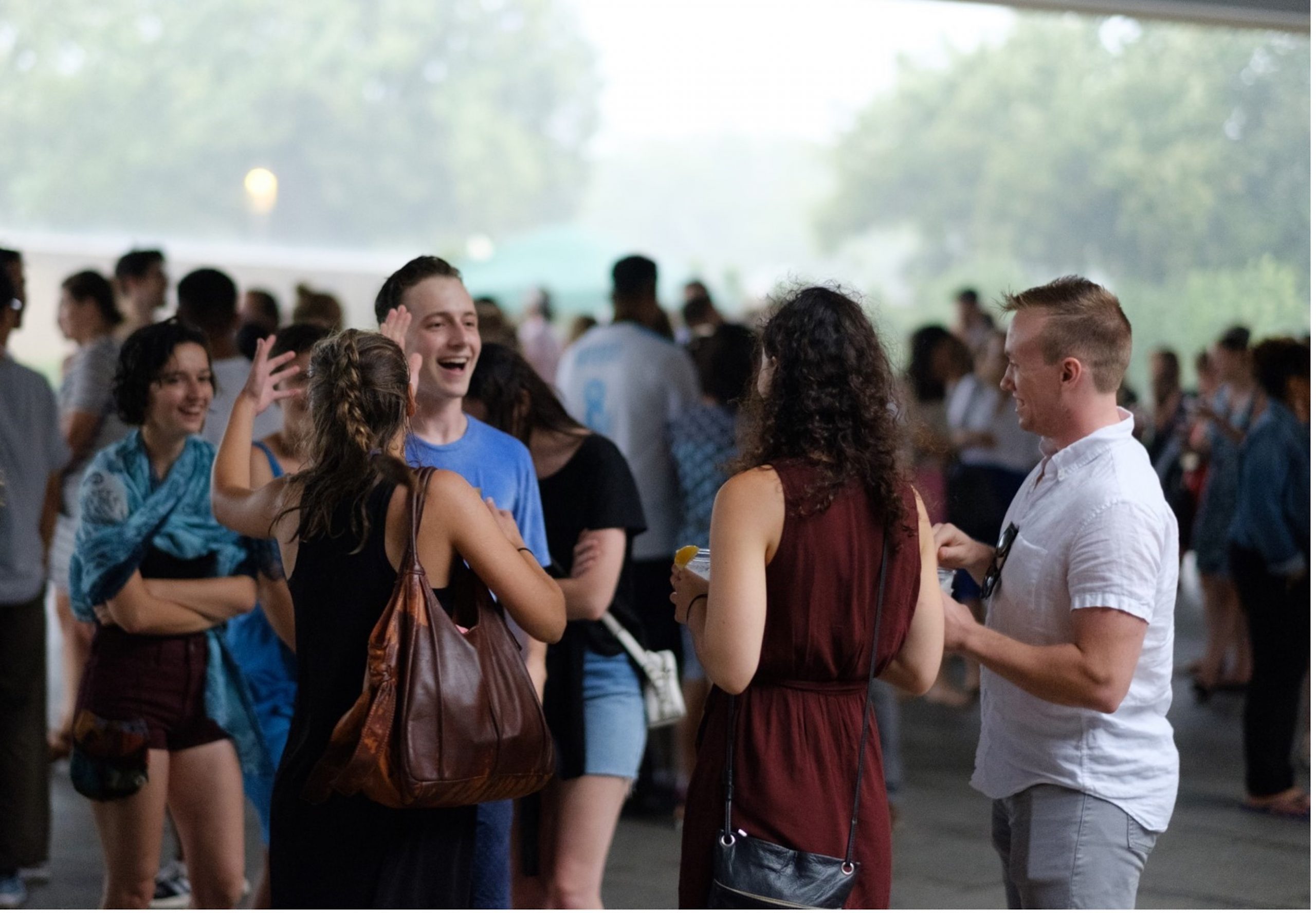 group of visitors laughing in the plaza