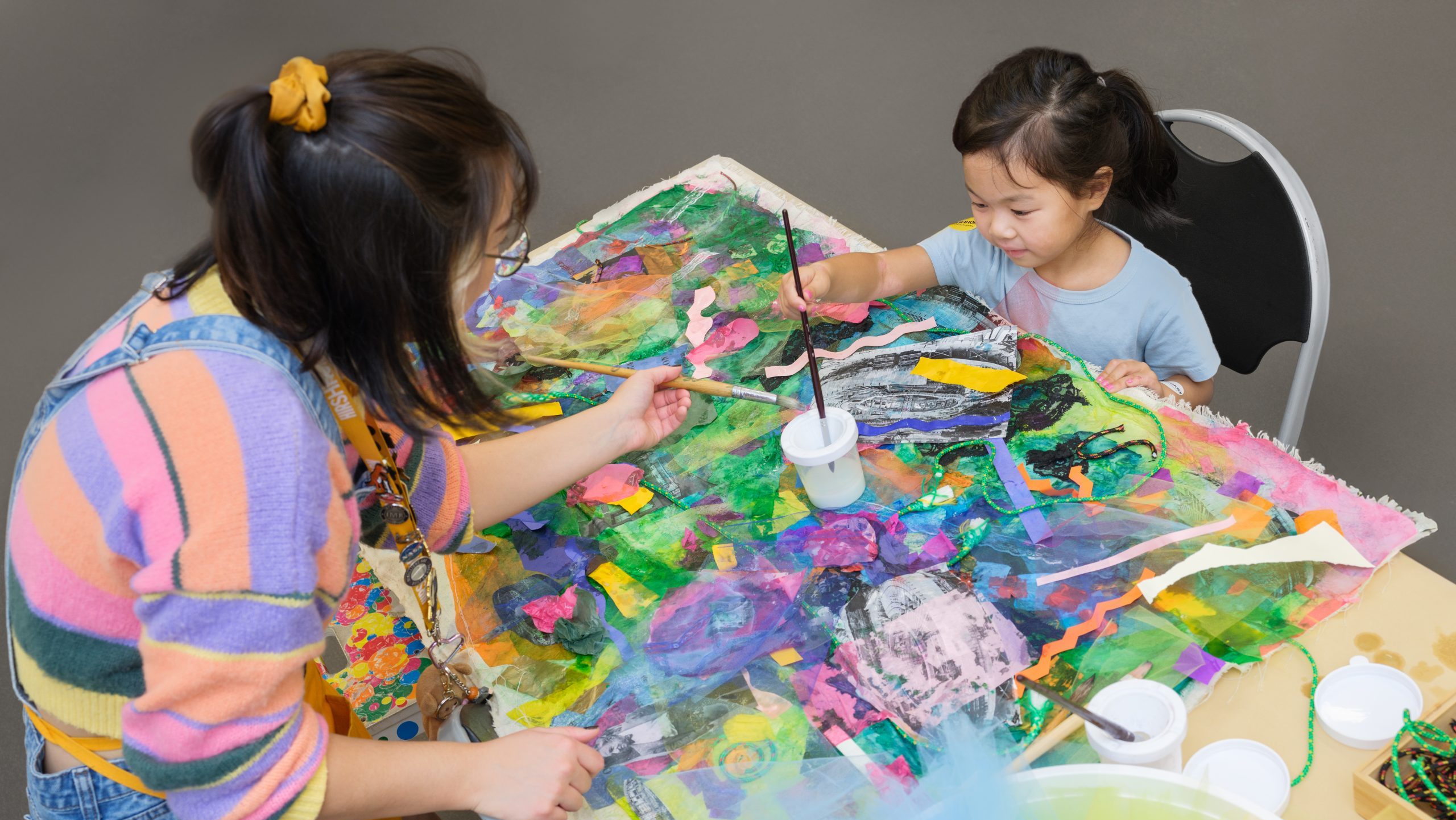 Child painting with adult