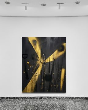 a black and yellow abstract painting is displayed on a white wall